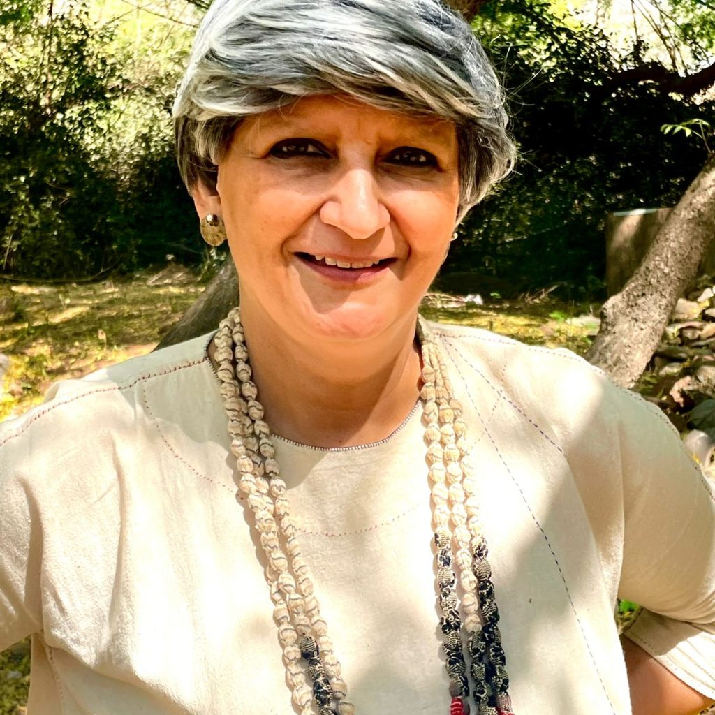 Headshot of Kavita Singh, who is in a garden.