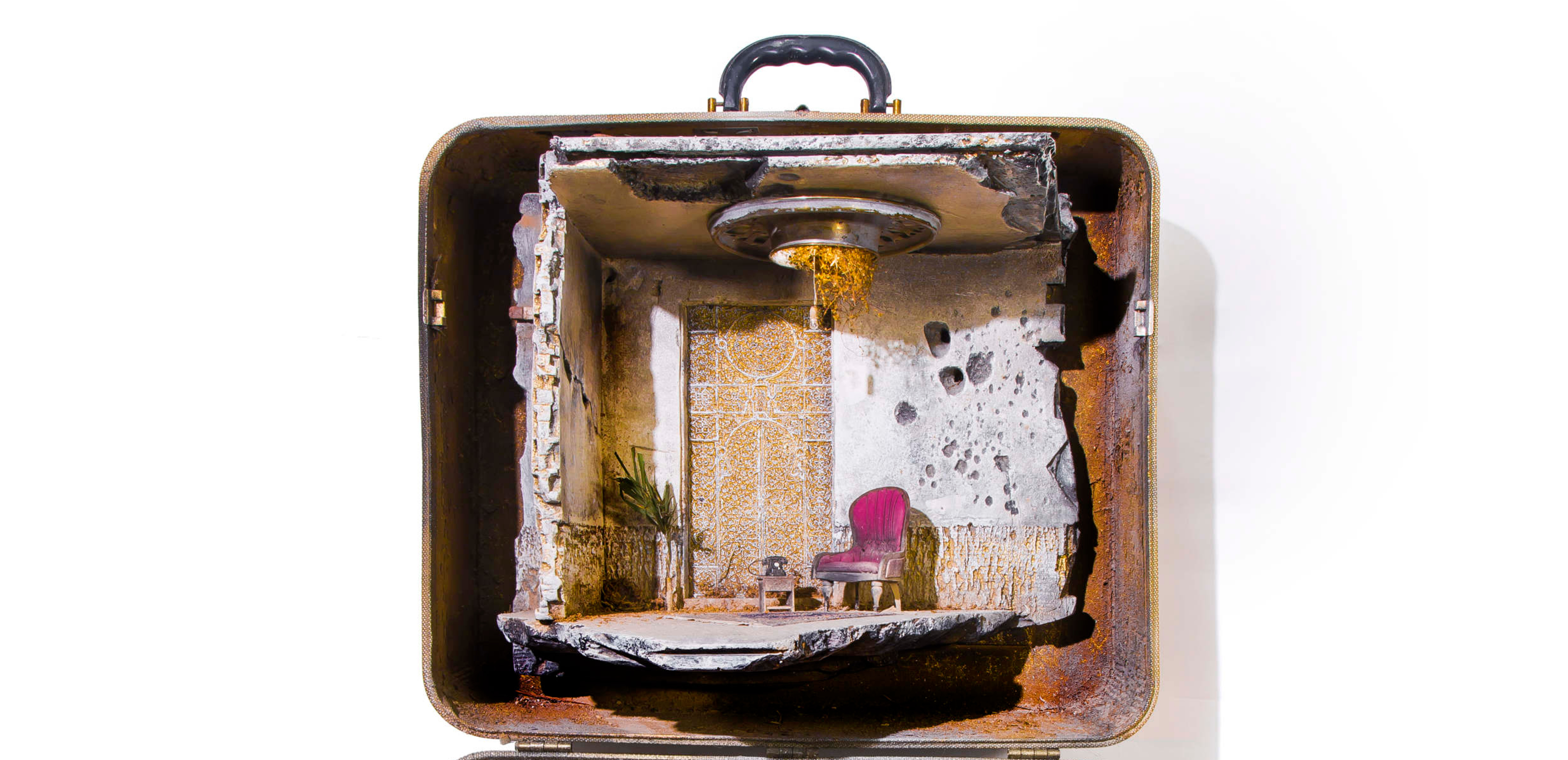 A minature diorama inside a suitcase.