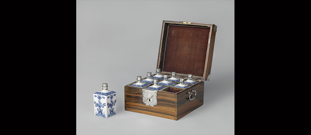 A wooden box containing nine porcelain bottles.