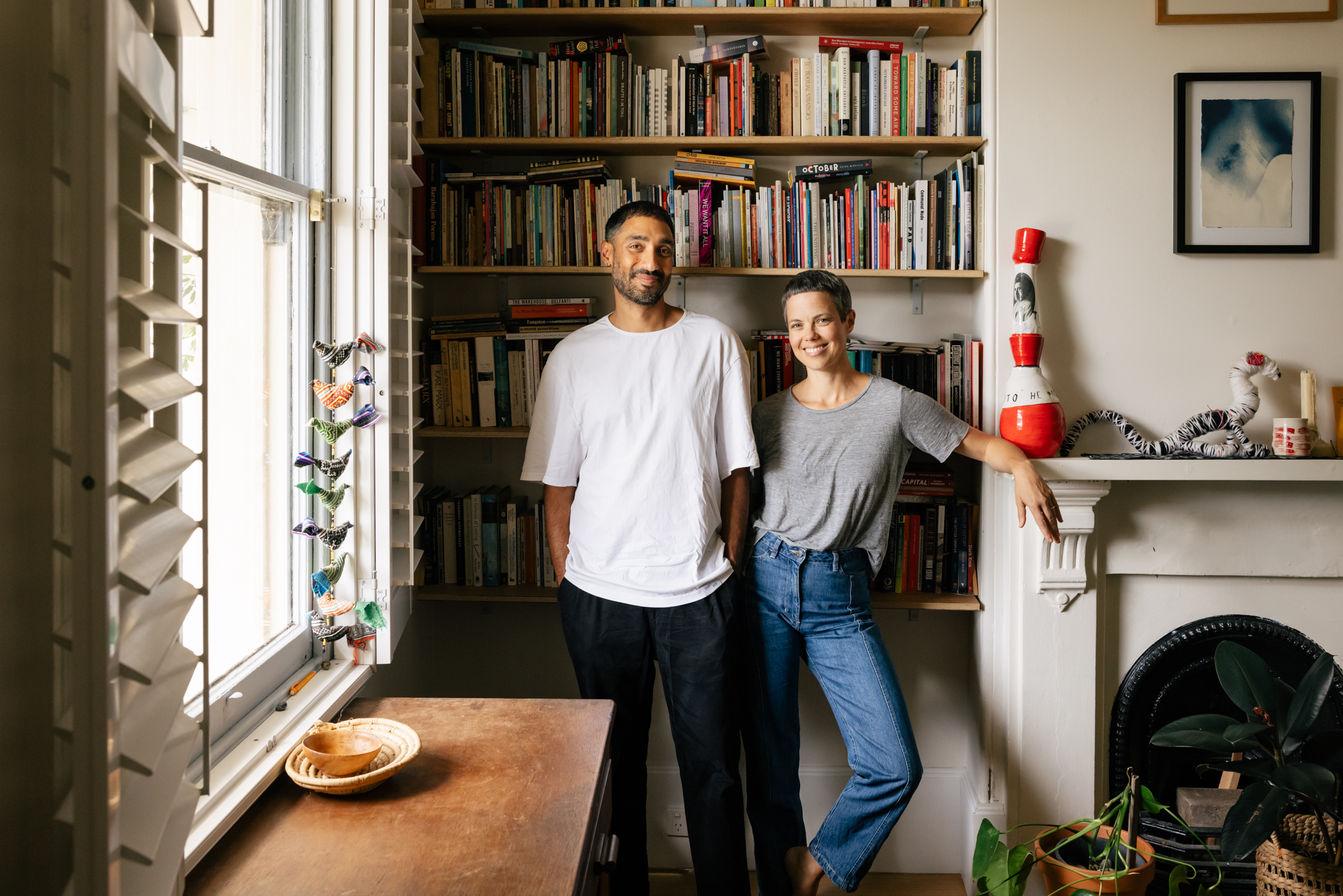 A picture of Andrew Brooks and Astrid Lorange standing in front of a bookcase.