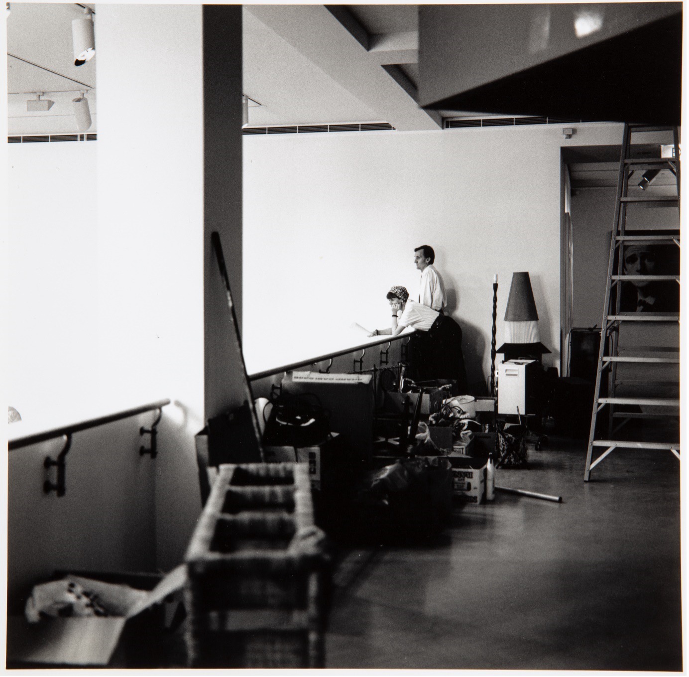 A photograph of Bernice Murphy and Leon Paroissien installing an exhibition at the Museum of Contemporary Art