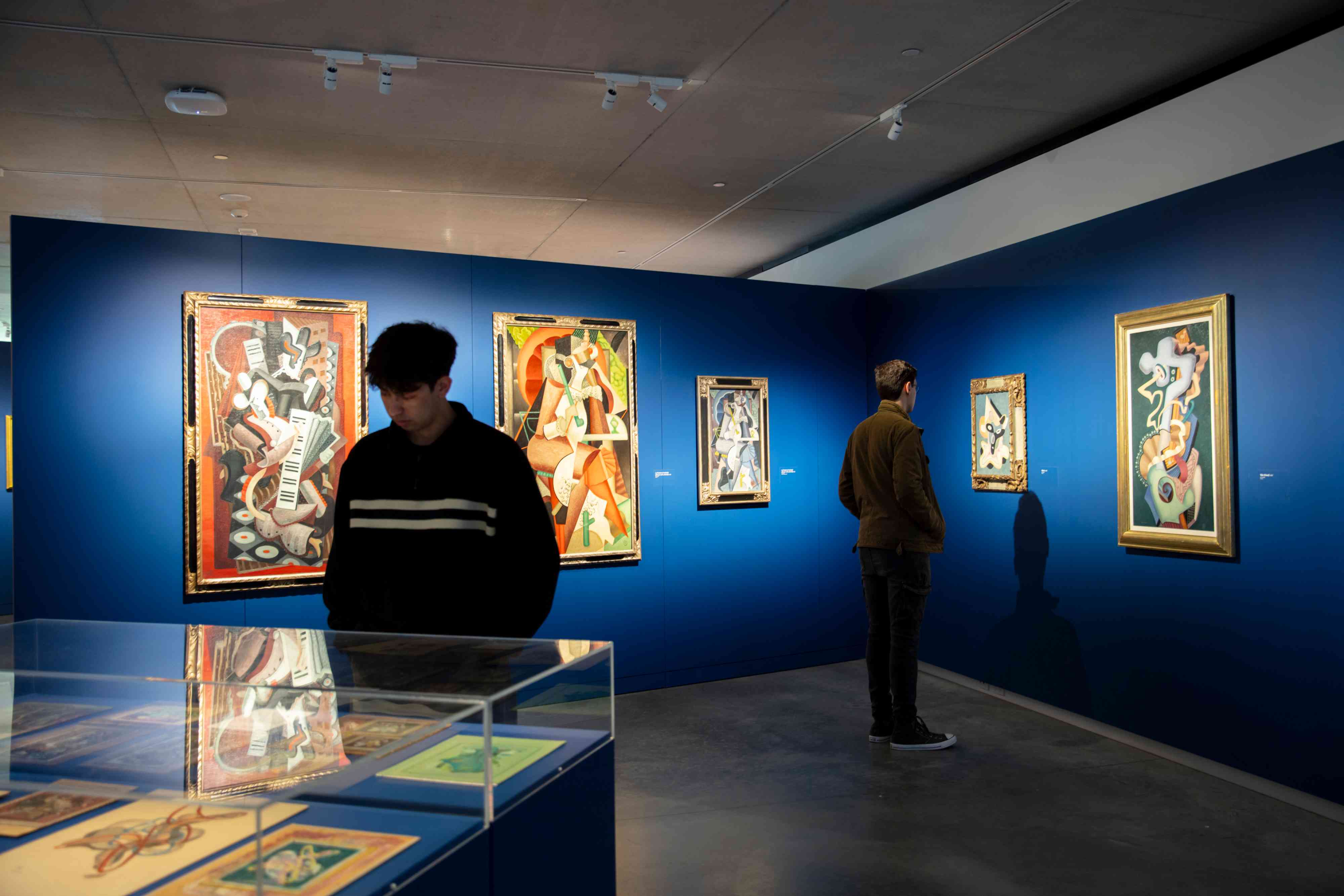 A photograph of two men standing in an exhibition.