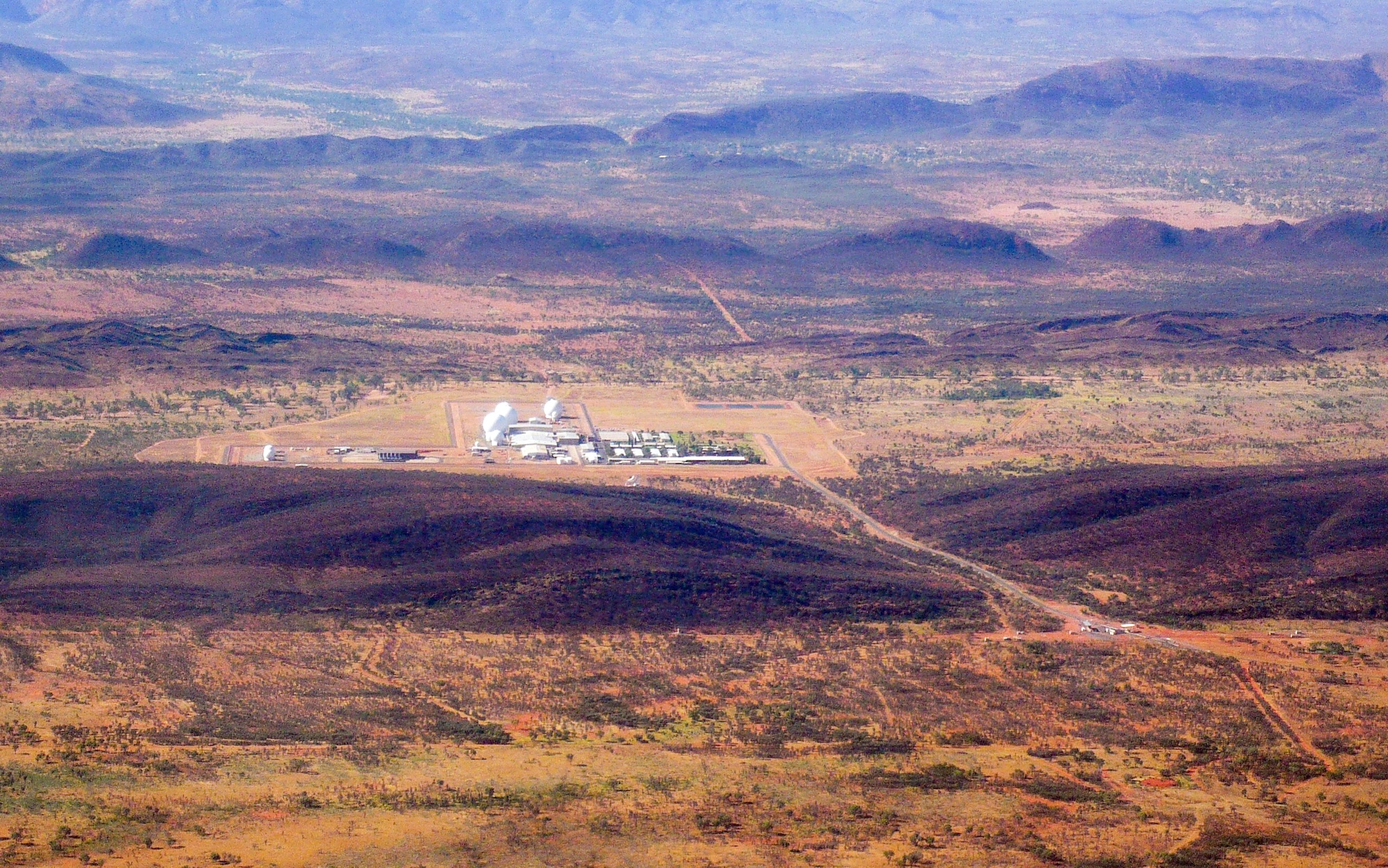 An aerial photograph showing, in the distance, Pine Gap Satellite Tracking Station