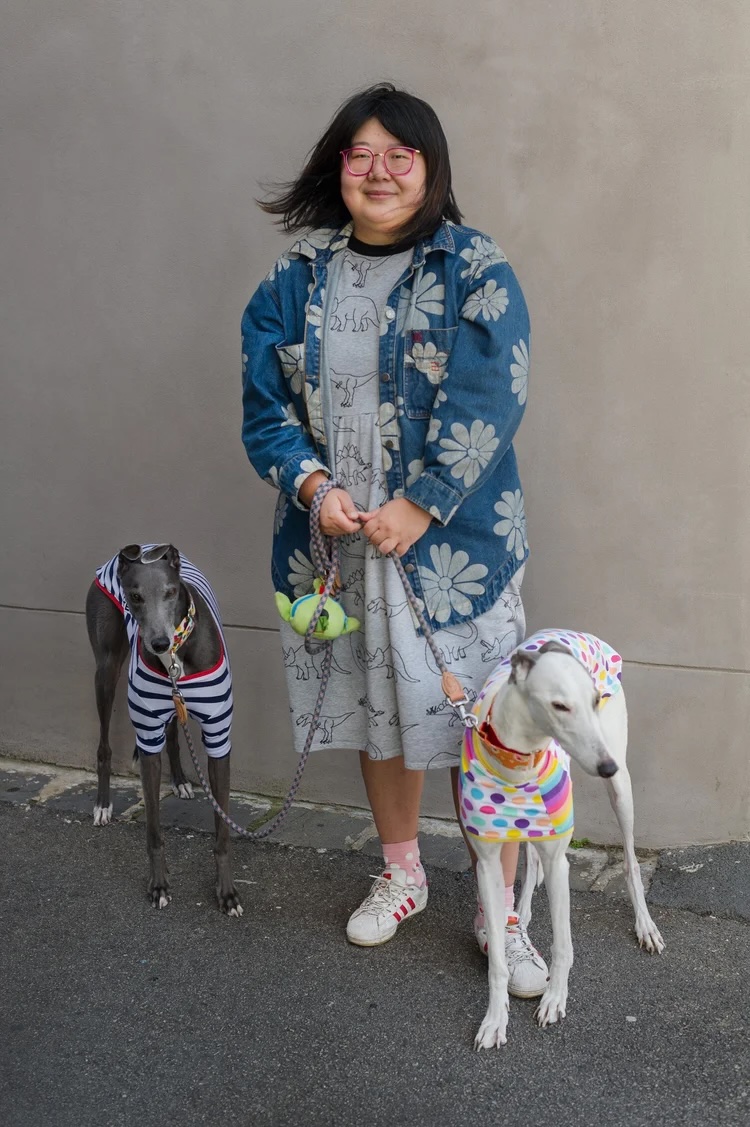 A photograph of Sophia Cai and two dogs