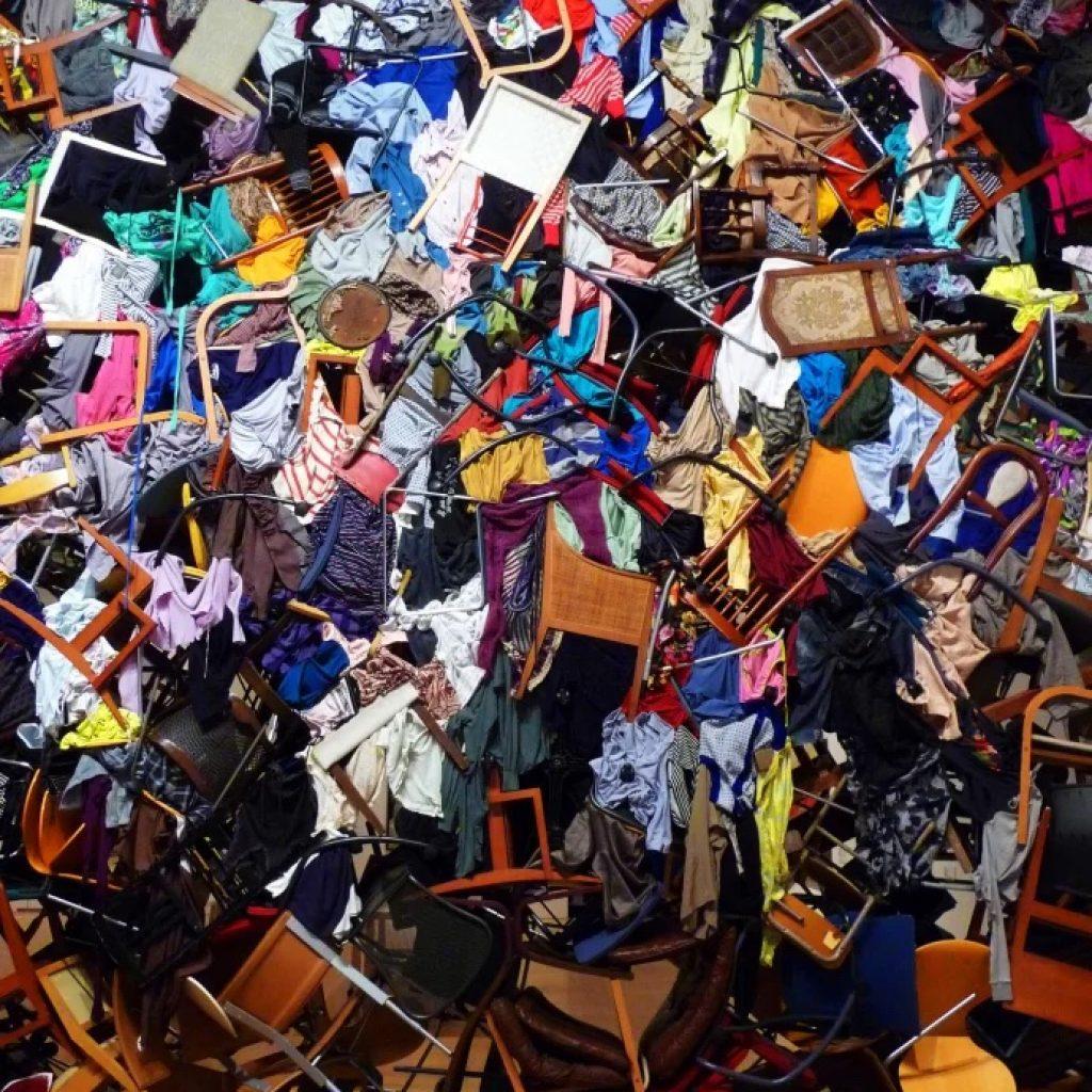 Chairs and clothing stacked together.