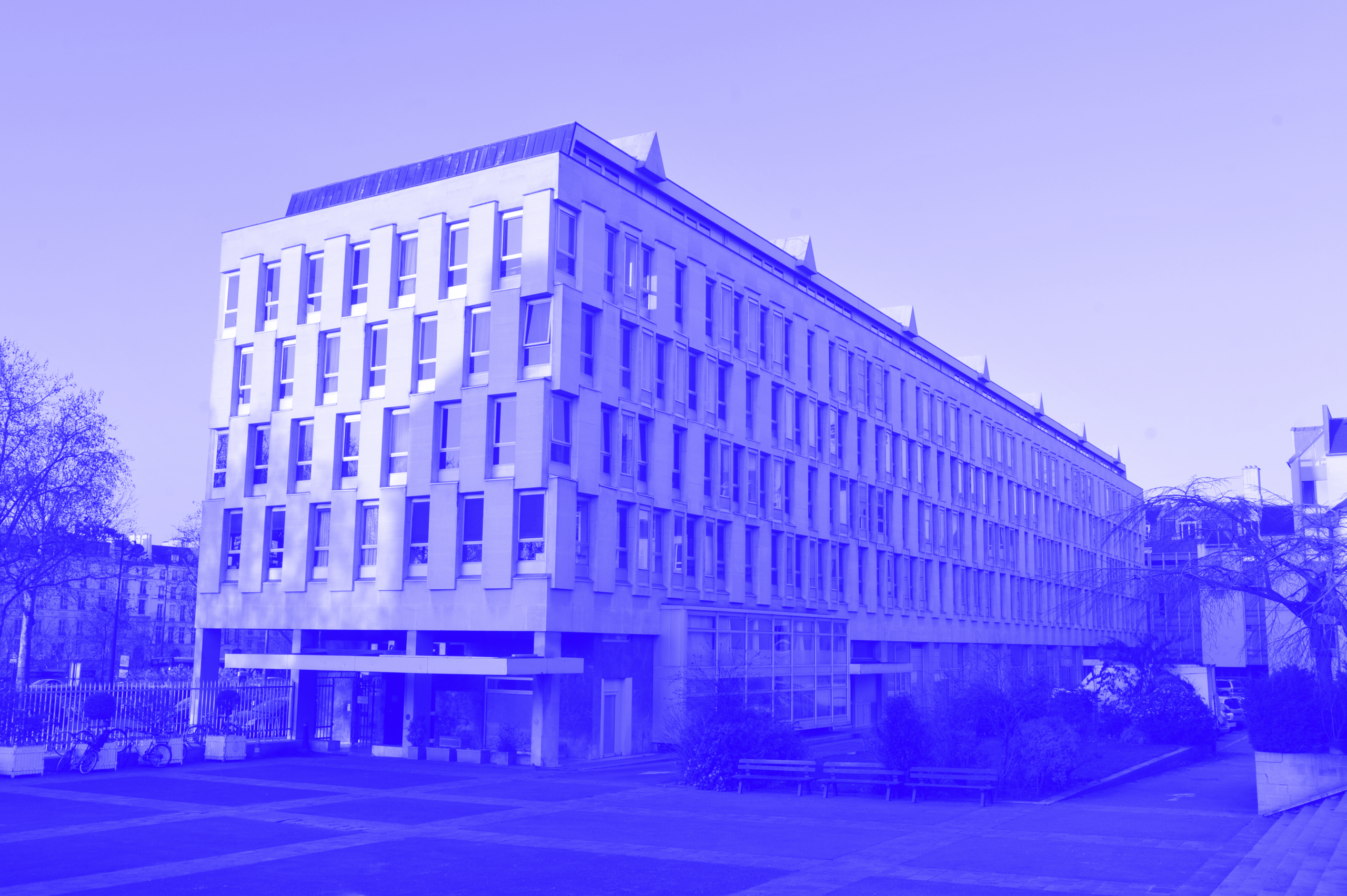 A blue and white photograph of the Cité des Arts Internationales in Paris