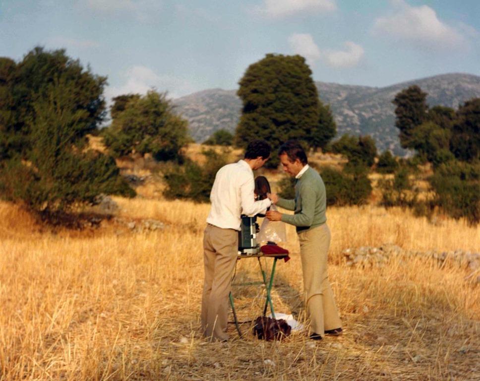 Gregory Markopoulous and Robert Beaver standing together in a field.