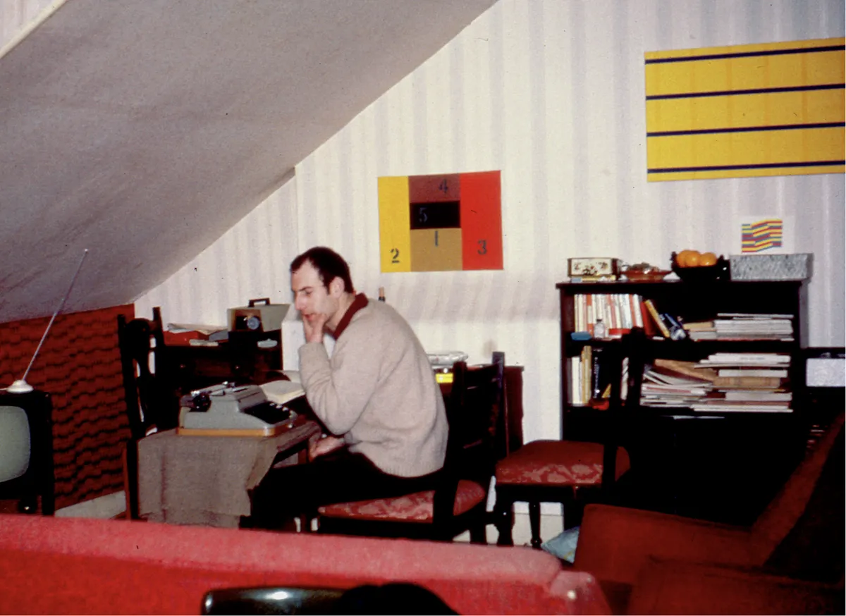 Ian Burn sitting at his desk in London.